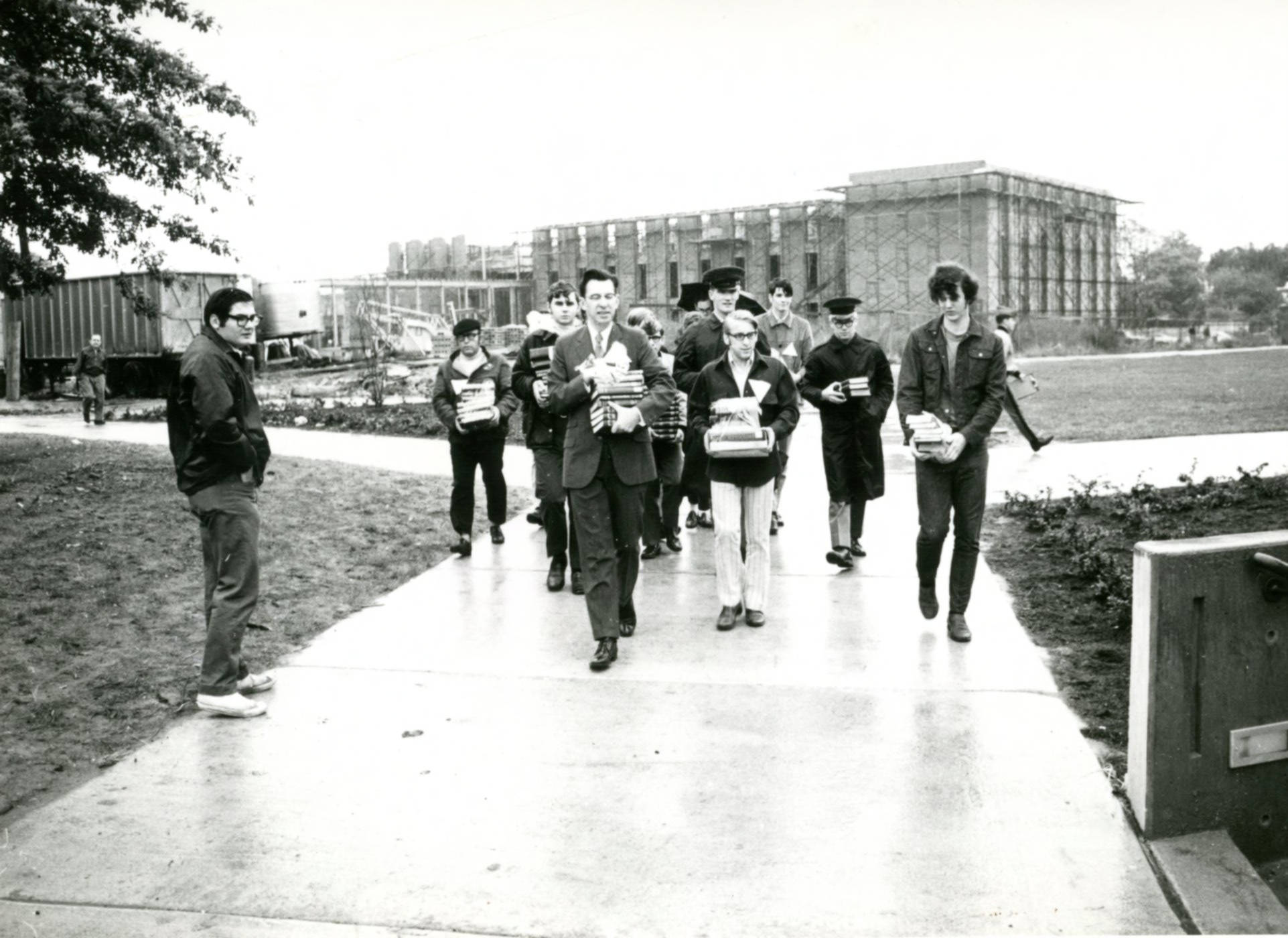 Students and faculty walk books to the new Wolfgram Memorial Library in 1970
