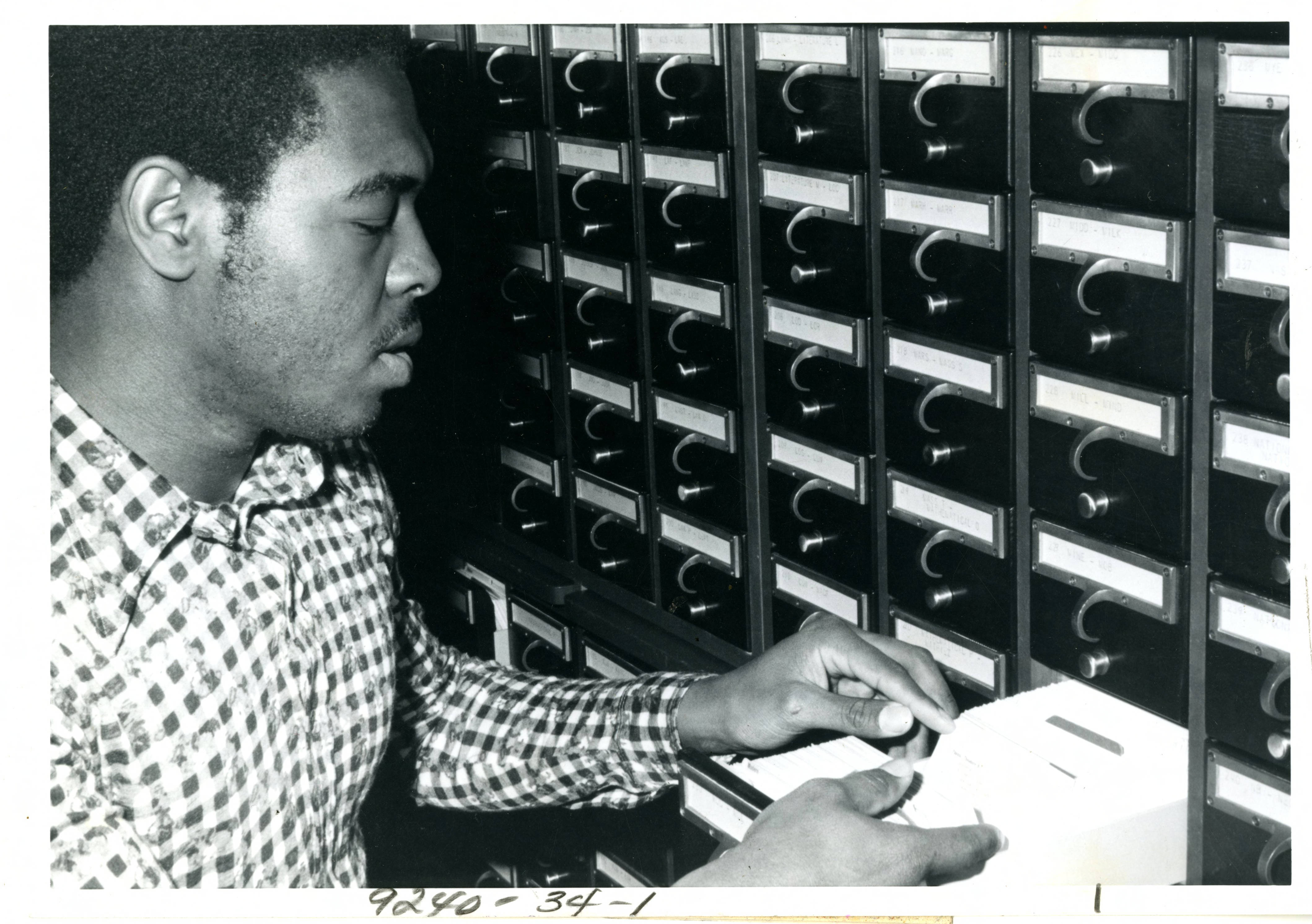A student uses an original card catalog in the library c. 1970