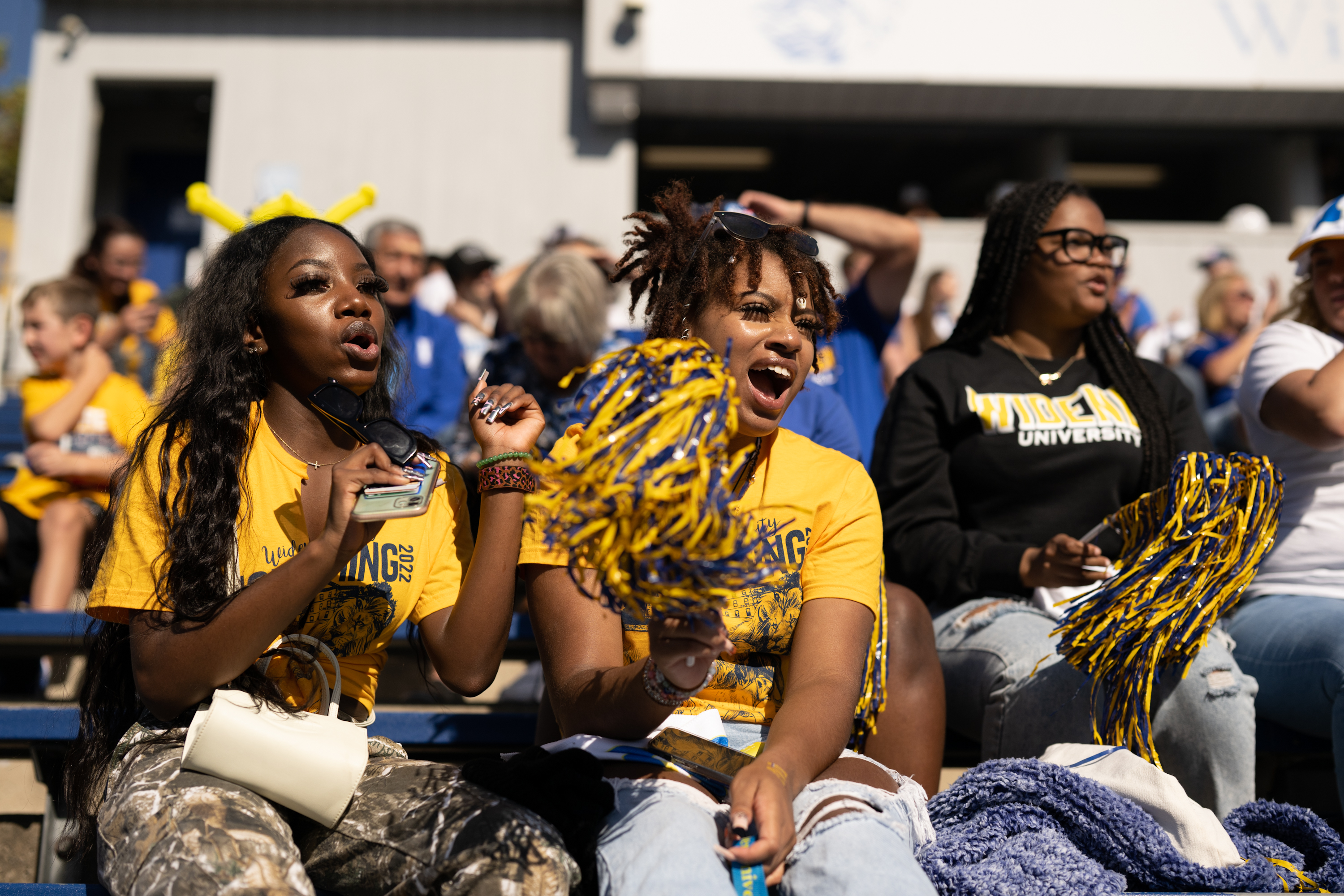 Students cheer in the stands at Homecoming.