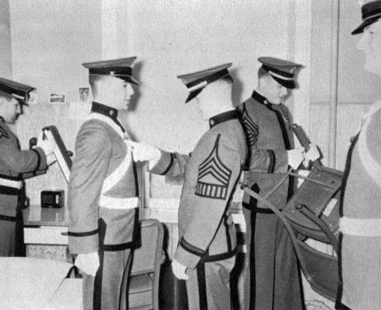 A member of the Saturday morning inspection team performs a white glove inspection.