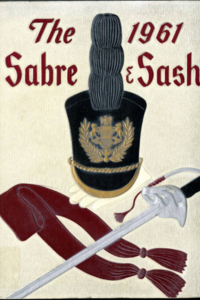 (e.g., PMC-1961 Yearbook Cover beige background with title in a dark slight red color with a military hat and sword design)